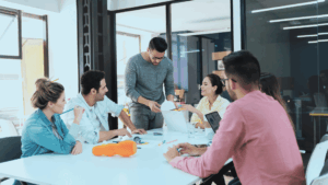 Team brainstorming in a conference room with a prototype on the table